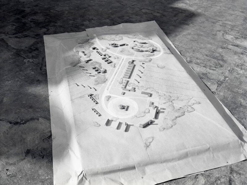 An architectural model depicting a modern farmyard and its adjacent cityscape