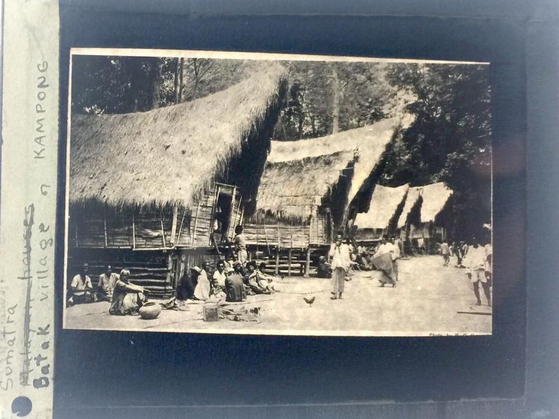 A photograph of a village and people