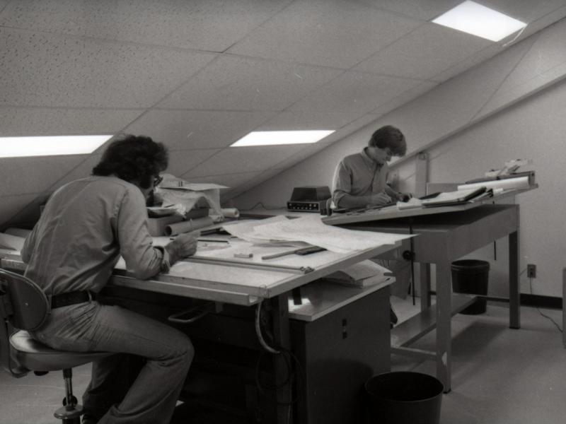 Two students working at drafting tables